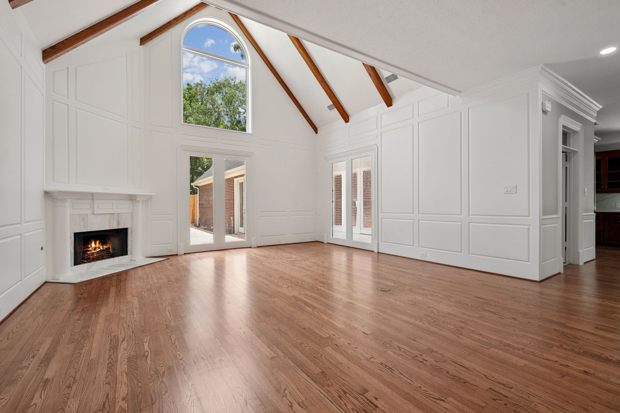 18489 Country Pl Drive Conroe, TX 77302 - Photo 8 of 50 a view of an empty room with wooden floor fireplace and a window