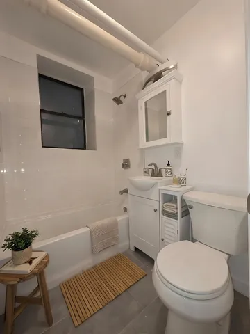 a bathroom with a sink toilet and mirror