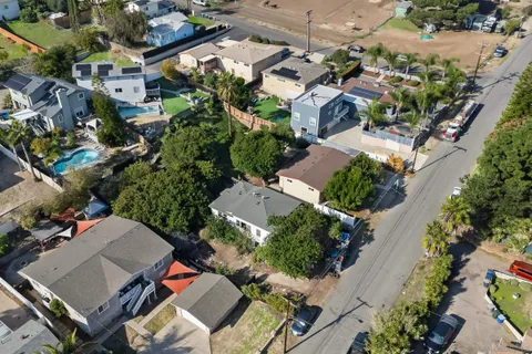 an aerial view of multiple houses with yard