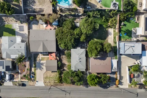 an aerial view of a house with a yard and garden