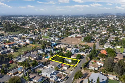 an aerial view of residential building with green space