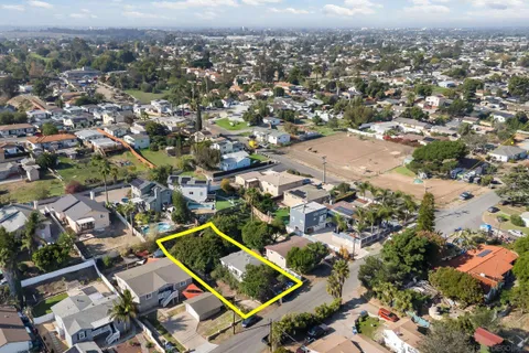 an aerial view of residential houses with city view
