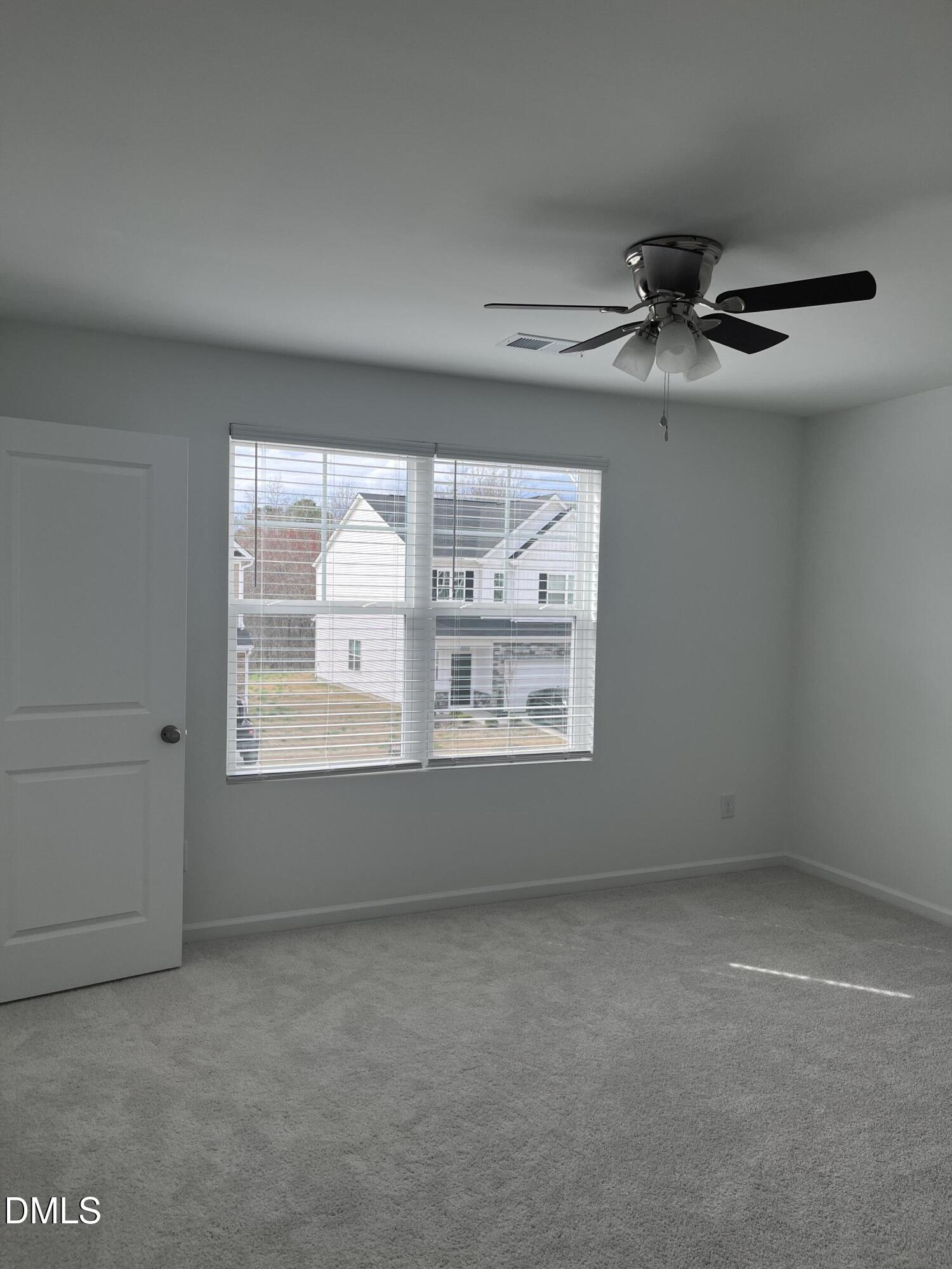 1028 Red Finch Way Angier, NC 27501 - Photo 14 of 50 an empty room with a empty space and windows