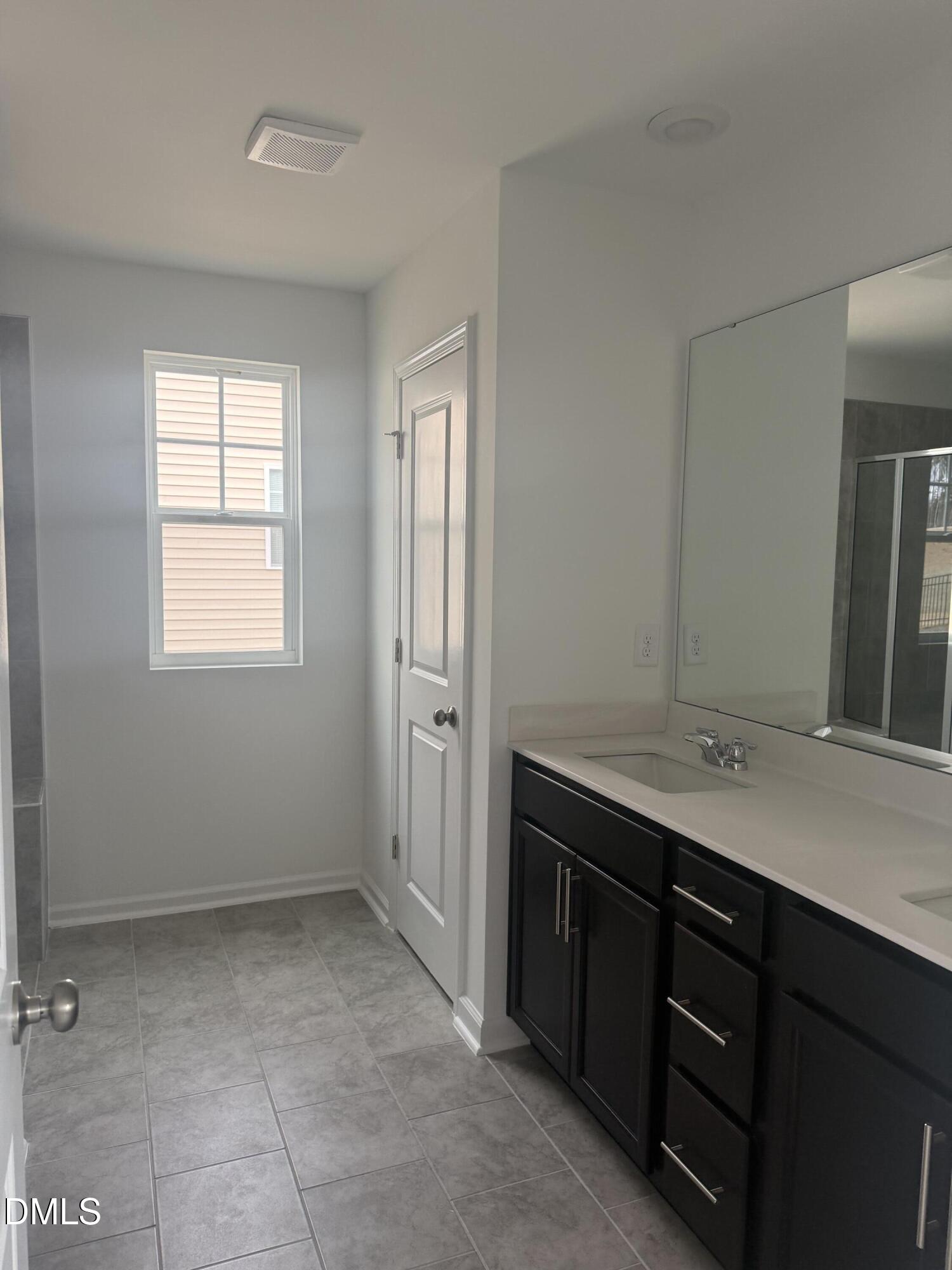 1028 Red Finch Way Angier, NC 27501 - Photo 26 of 50 a bathroom with a sink a vanity and a mirror