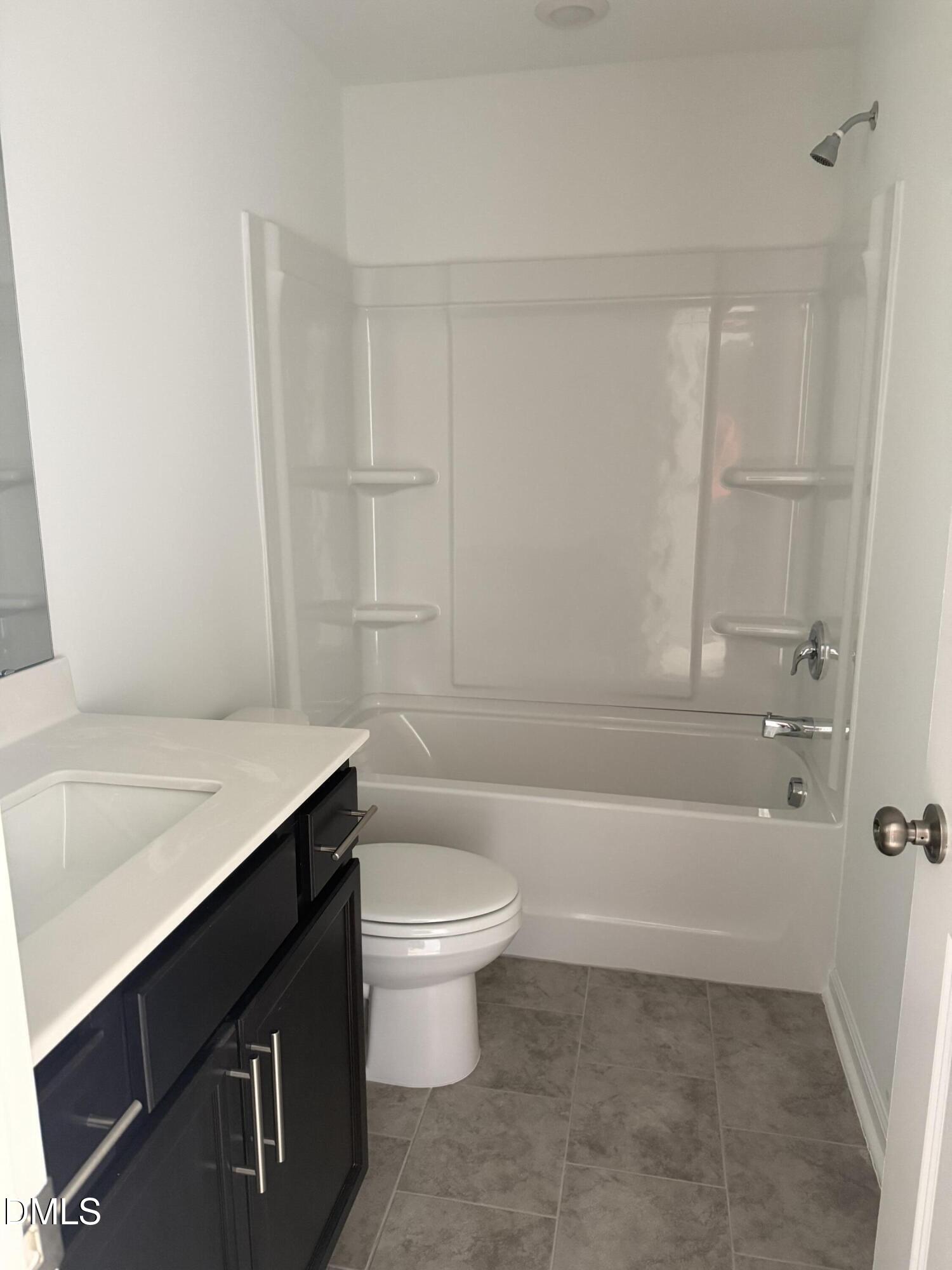 1028 Red Finch Way Angier, NC 27501 - Photo 28 of 50 a bathroom with a sink a toilet and bathtub