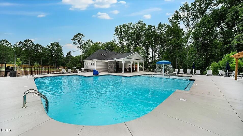 1028 Red Finch Way Angier, NC 27501 - Photo 47 of 50 a view of a swimming pool with a garden