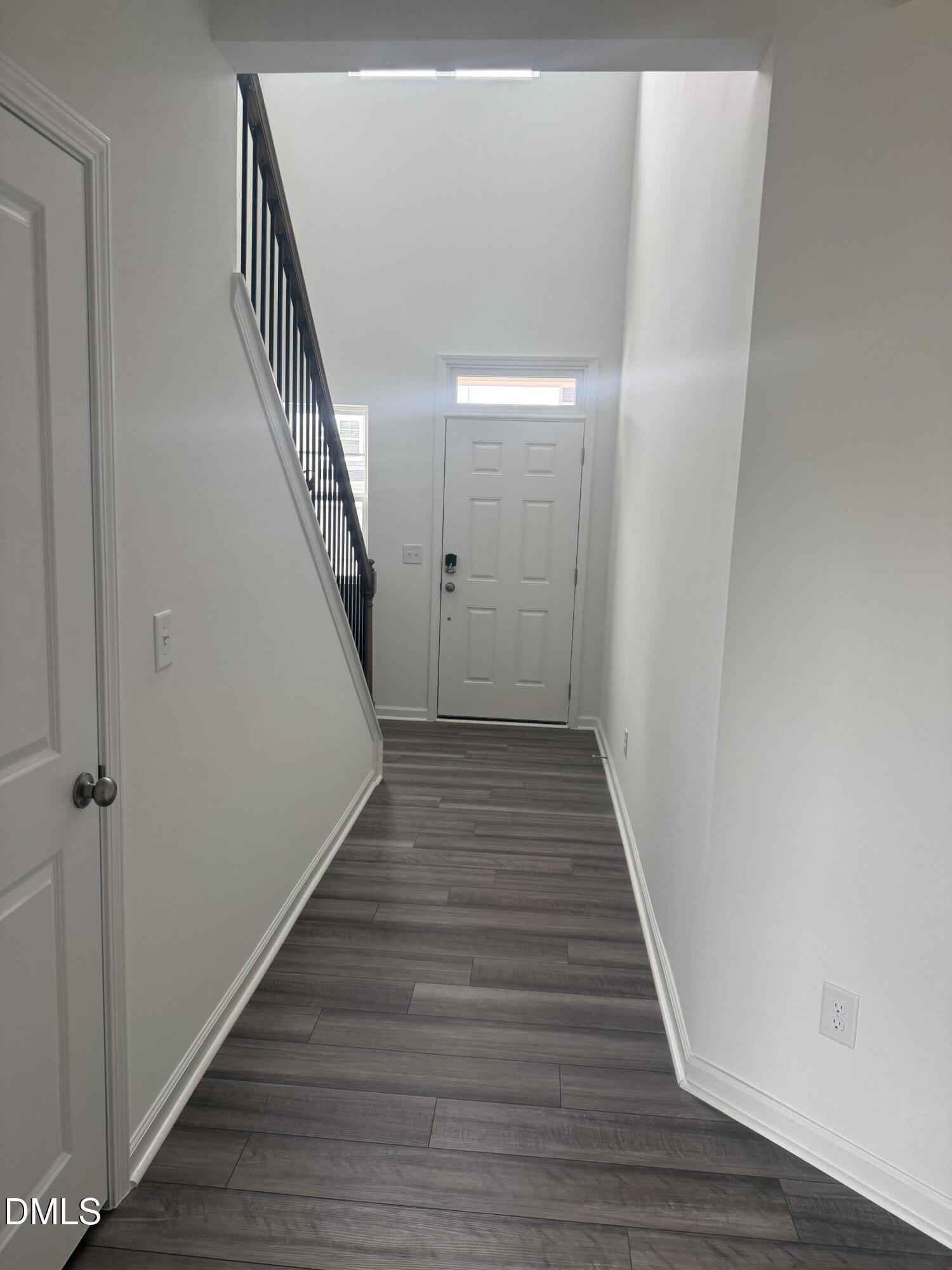 1028 Red Finch Way Angier, NC 27501 - Photo 4 of 50 a view of a hallway with wooden floor and staircase