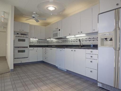 112 Avon Road Northbrook, IL 60062 - Photo 6 of 16 a kitchen with white cabinets and white appliances