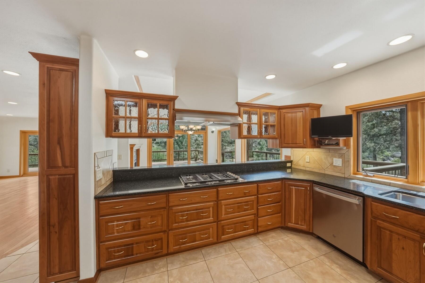 637 Northwest Silver Buckle Road Bend, OR 97703 - Photo 16 of 68 Ample cherry cabinetry and granite counter tops. All appliances stay.