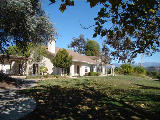 3083 Dos Lomas Fallbrook, CA 92028 - Photo 13 of 16 Cool trees and a fire pit are a short walk from the side patio.