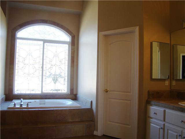 3083 Dos Lomas Fallbrook, CA 92028 - Photo 9 of 16 The master bath features beautiful stone and leaded glass window.