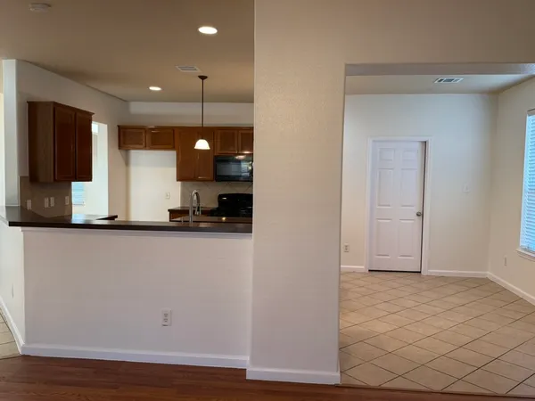 a view of a refrigerator in kitchen and wooden floor