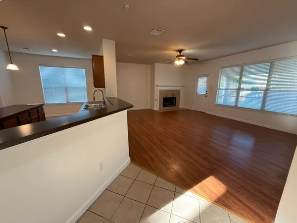 a kitchen with granite countertop a stove a sink and a microwave