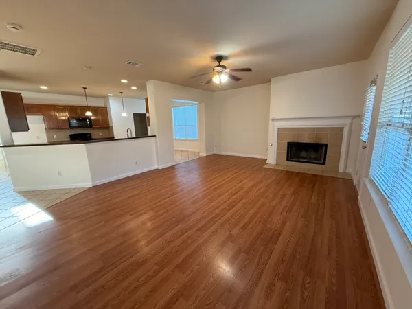 a view of a kitchen with a sink and a fireplace