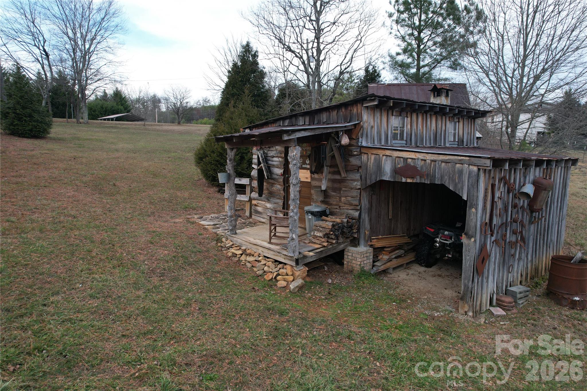 740 Moriah Church Road Casar, NC 28020 - Photo 5 of 31 a view of a wooden house with large trees and playing area