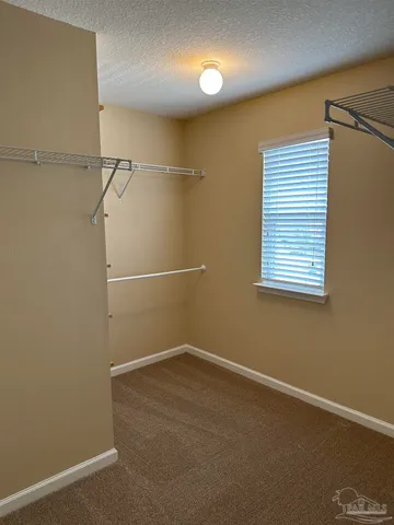 an empty room with wooden floor and closet