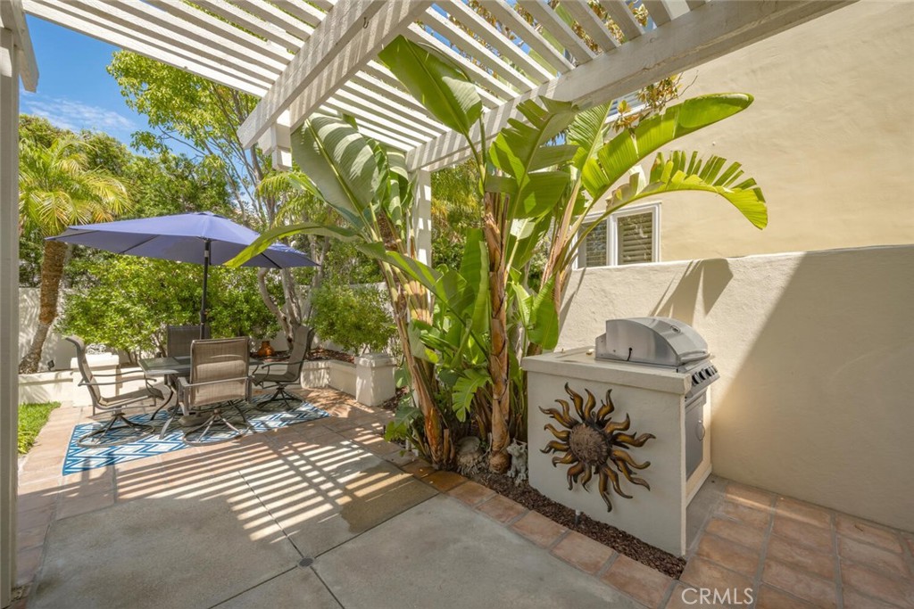 6546 Morningside Drive Huntington Beach, CA 92648 - Photo 12 of 74 a view of a patio with table and chairs under an umbrella