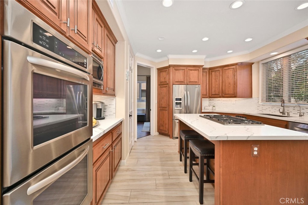 6546 Morningside Drive Huntington Beach, CA 92648 - Photo 34 of 74 a kitchen with stainless steel appliances granite countertop wooden cabinets a sink and dishwasher