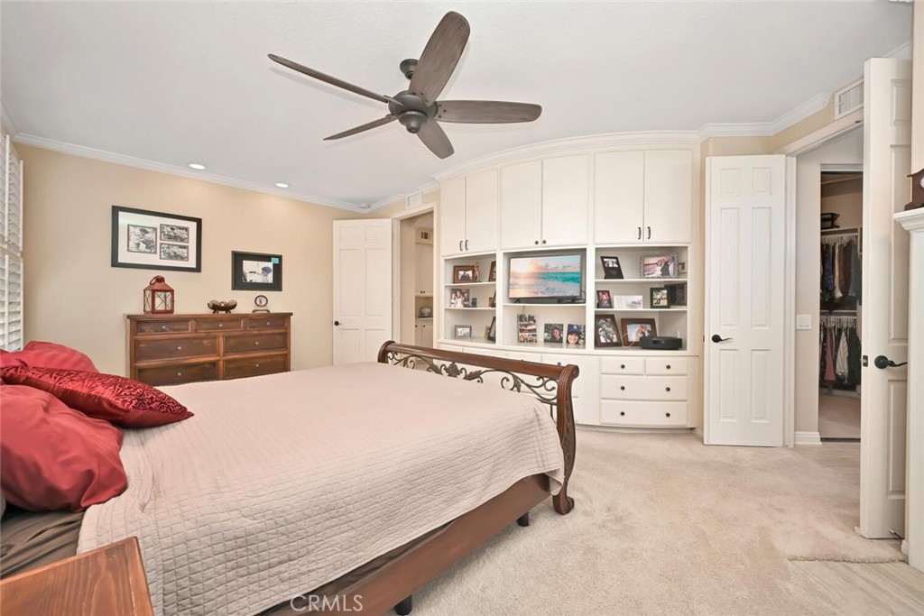 6546 Morningside Drive Huntington Beach, CA 92648 - Photo 48 of 74 a bedroom with a bed a large window and a chandelier