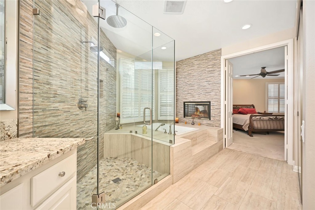 6546 Morningside Drive Huntington Beach, CA 92648 - Photo 51 of 74 a spacious bedroom with a bed and a fireplace