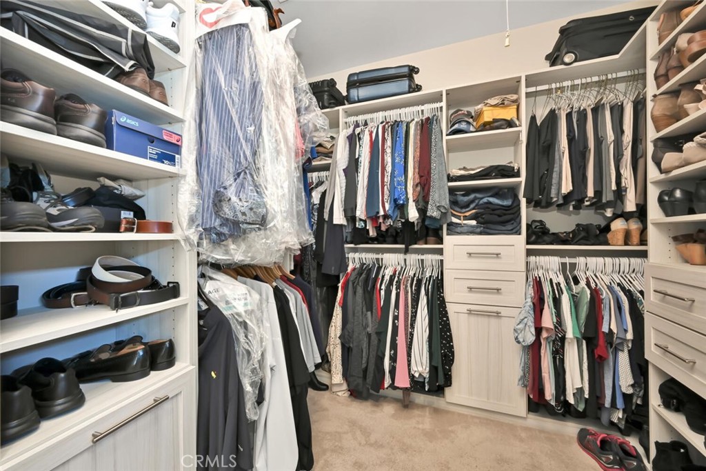 6546 Morningside Drive Huntington Beach, CA 92648 - Photo 54 of 74 a view of walk in closet with clothes and shoes