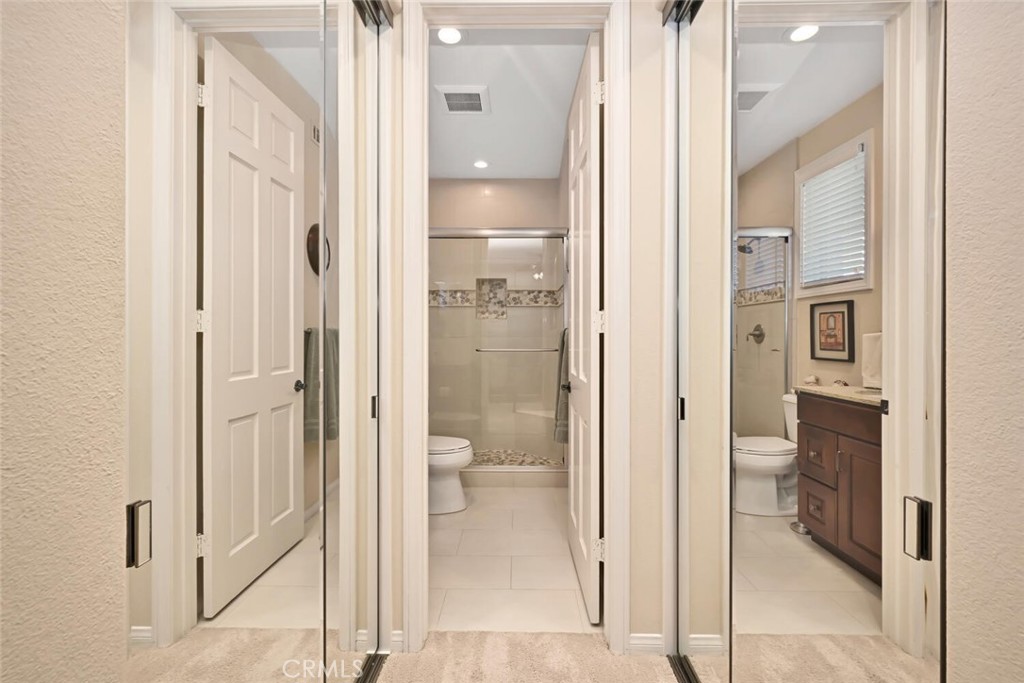 6546 Morningside Drive Huntington Beach, CA 92648 - Photo 55 of 74 a bathroom with a glass shower door and a mirror