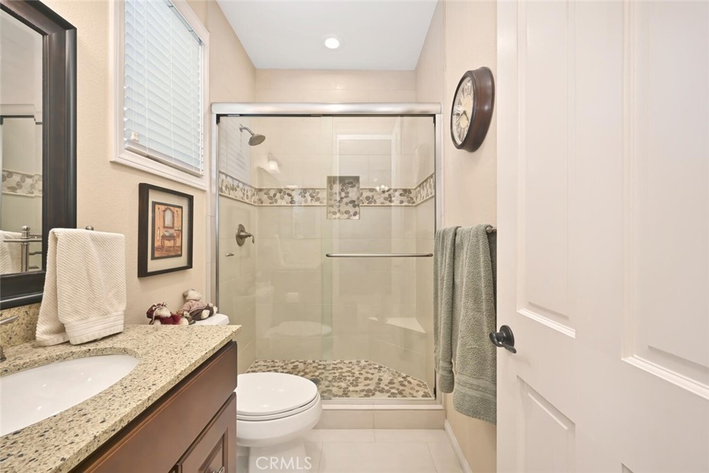 6546 Morningside Drive Huntington Beach, CA 92648 - Photo 57 of 74 a bathroom with a granite countertop sink a toilet and shower