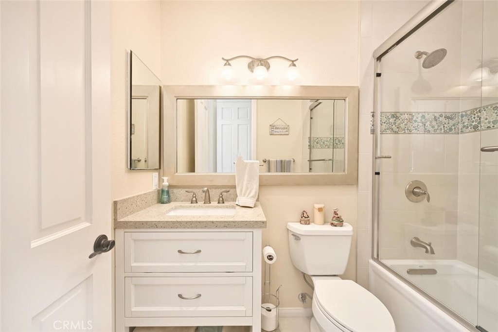 6546 Morningside Drive Huntington Beach, CA 92648 - Photo 62 of 74 a bathroom with a sink vanity mirror and toilet