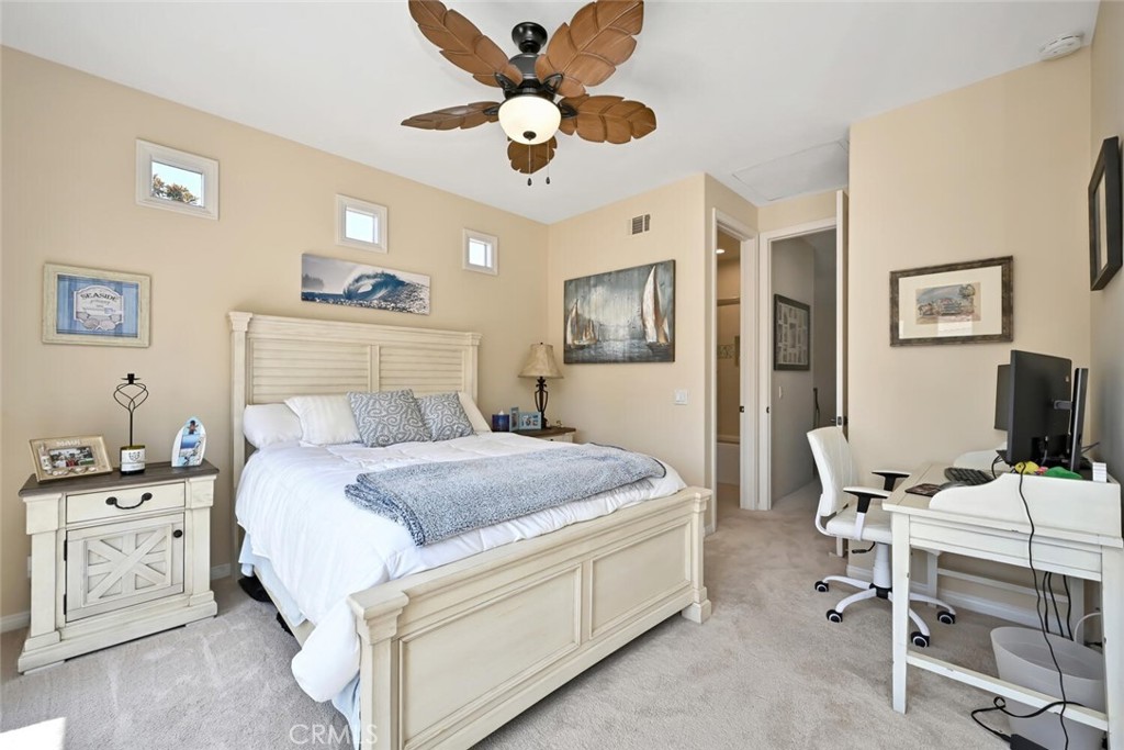 6546 Morningside Drive Huntington Beach, CA 92648 - Photo 64 of 74 a bedroom with a bed and a chandelier