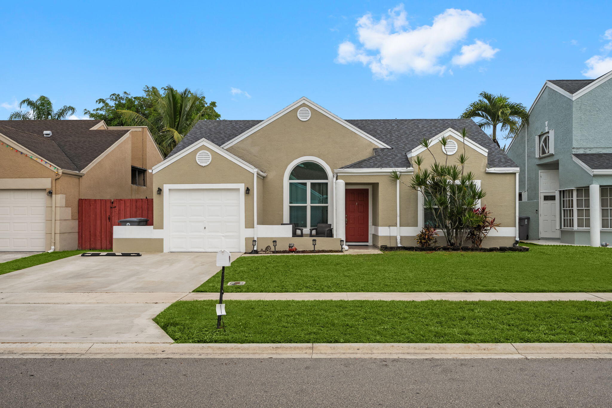 a front view of a house with a garden