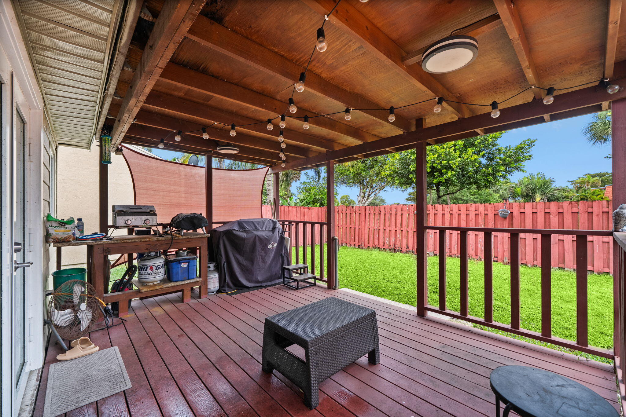 8374 Dynasty Drive Boca Raton, FL 33433 - Photo 20 of 30 a view of a roof deck with table and chairs a barbeque with wooden floor and roof with a garden view