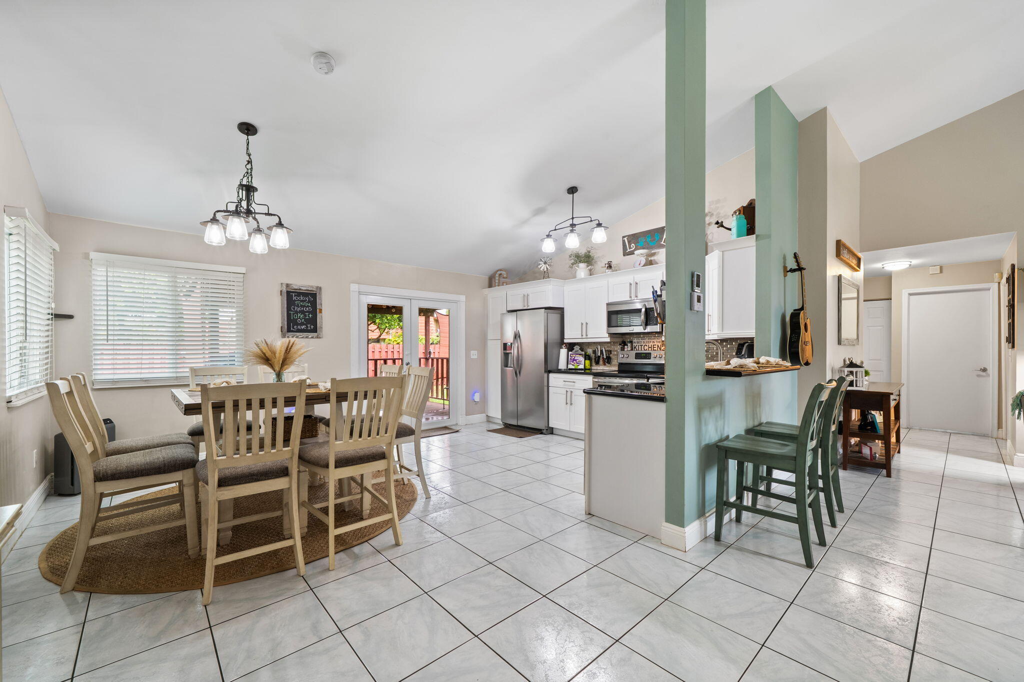 8374 Dynasty Drive Boca Raton, FL 33433 - Photo 6 of 30 a dining room filled chandelier and kitchen view