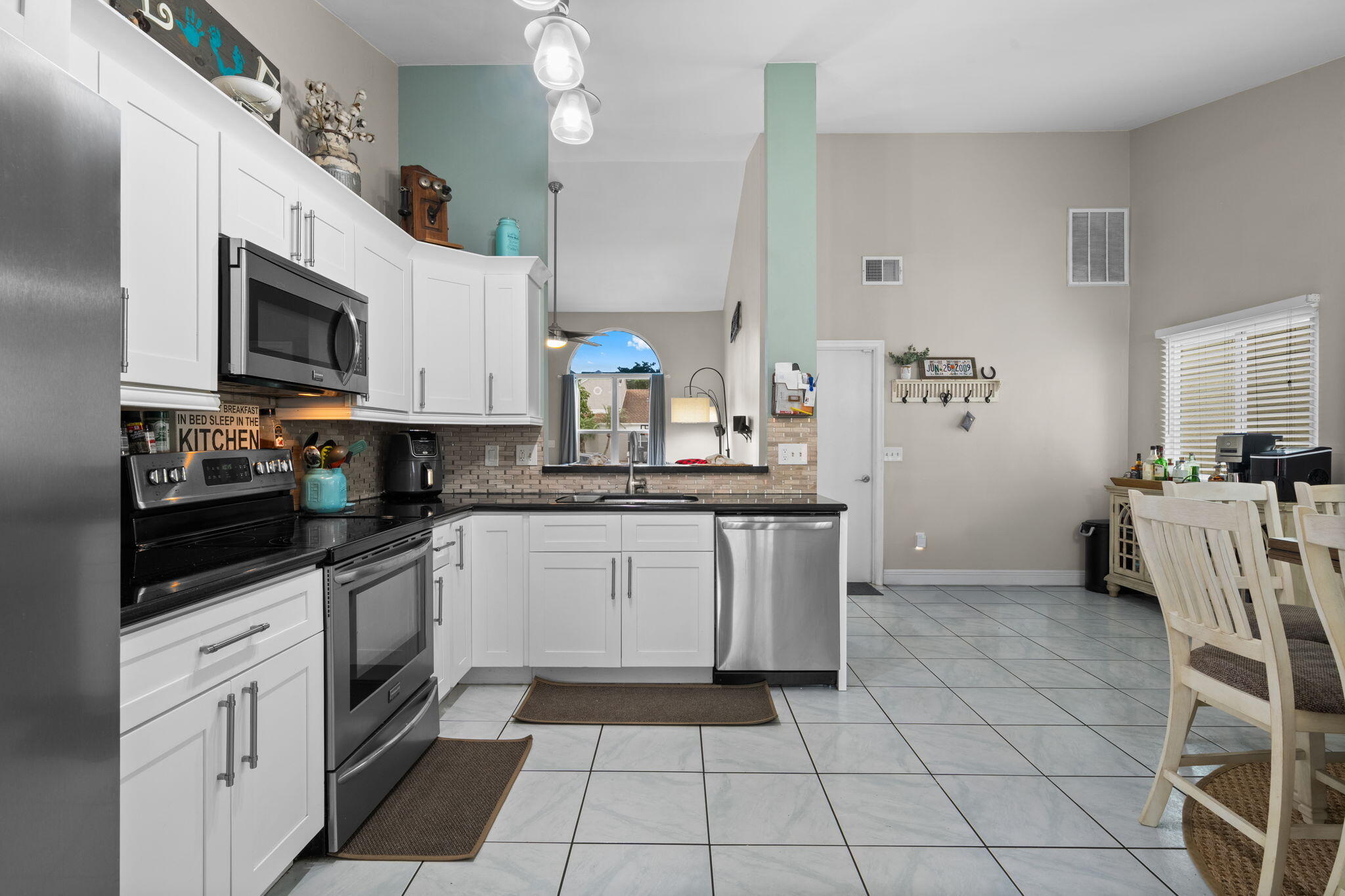 8374 Dynasty Drive Boca Raton, FL 33433 - Photo 9 of 30 a kitchen with a stove a sink and a microwave