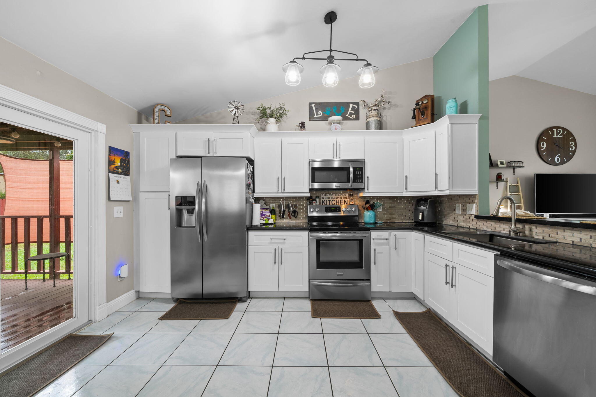 8374 Dynasty Drive Boca Raton, FL 33433 - Photo 10 of 30 a kitchen with stainless steel appliances a stove a refrigerator and white cabinets with wooden floor