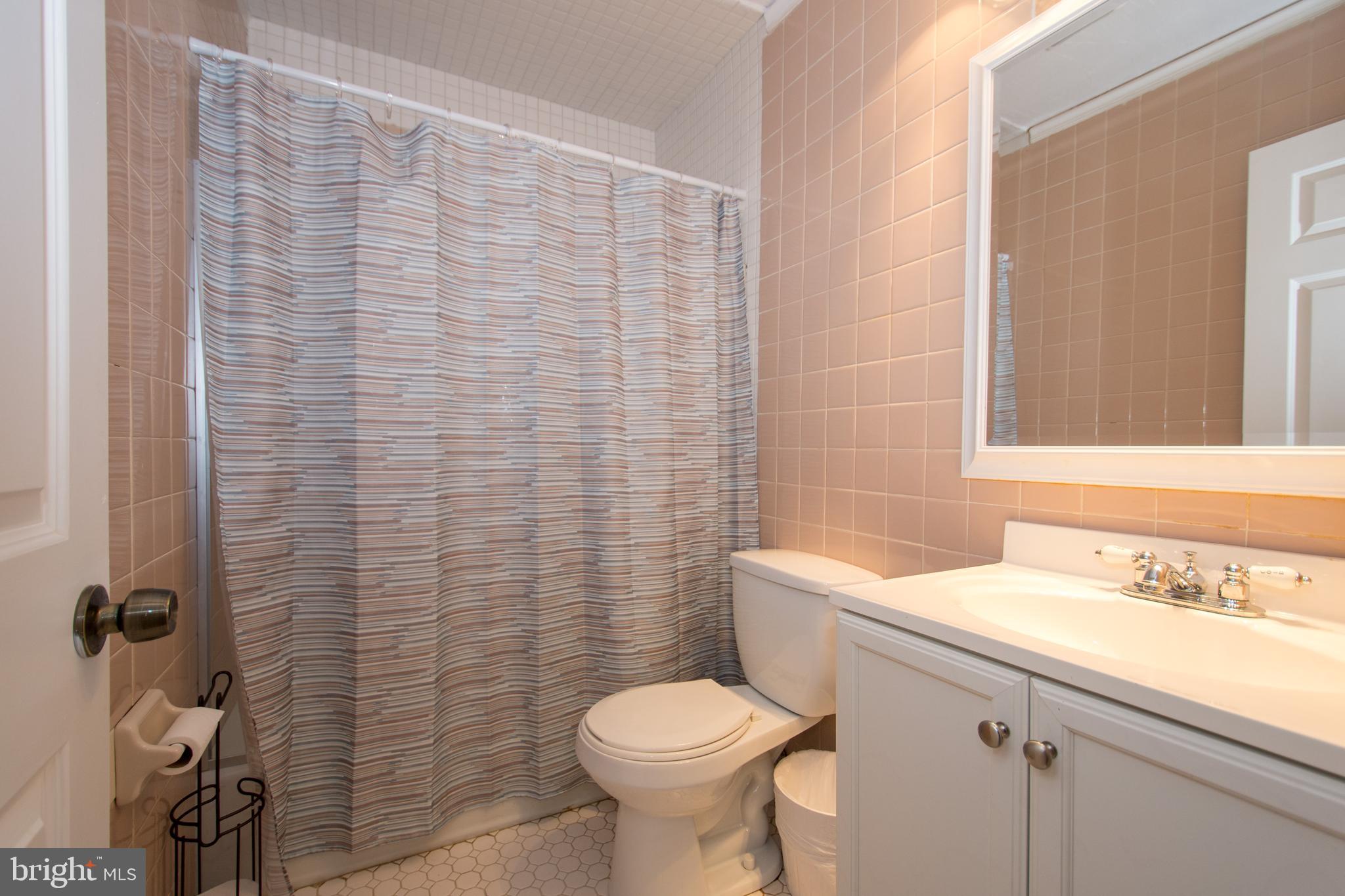 608 Charles Avenue Deale, MD 20751 - Photo 13 of 41 a bathroom with a sink a toilet and a mirror