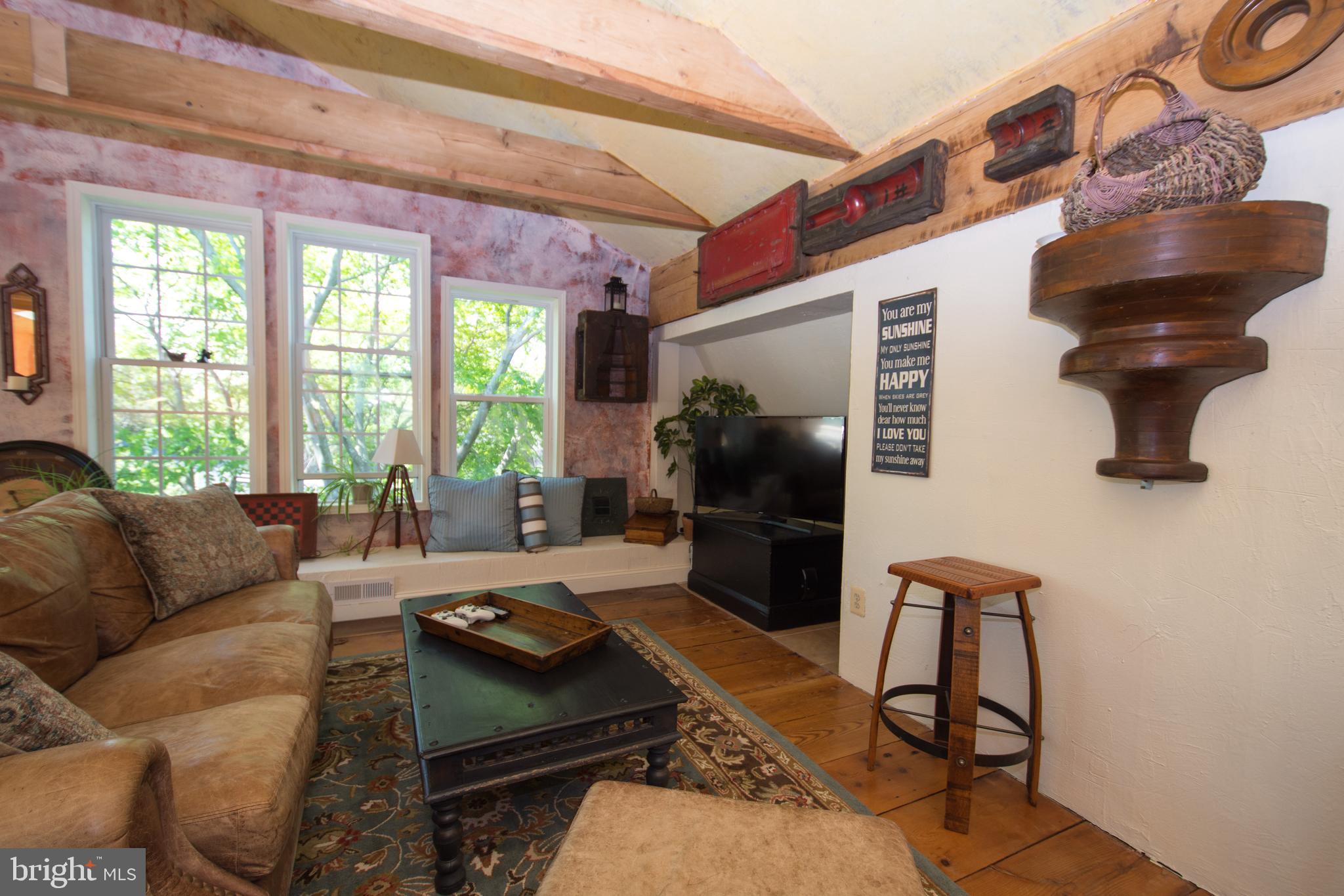 608 Charles Avenue Deale, MD 20751 - Photo 21 of 41 a living room with furniture and a floor to ceiling window