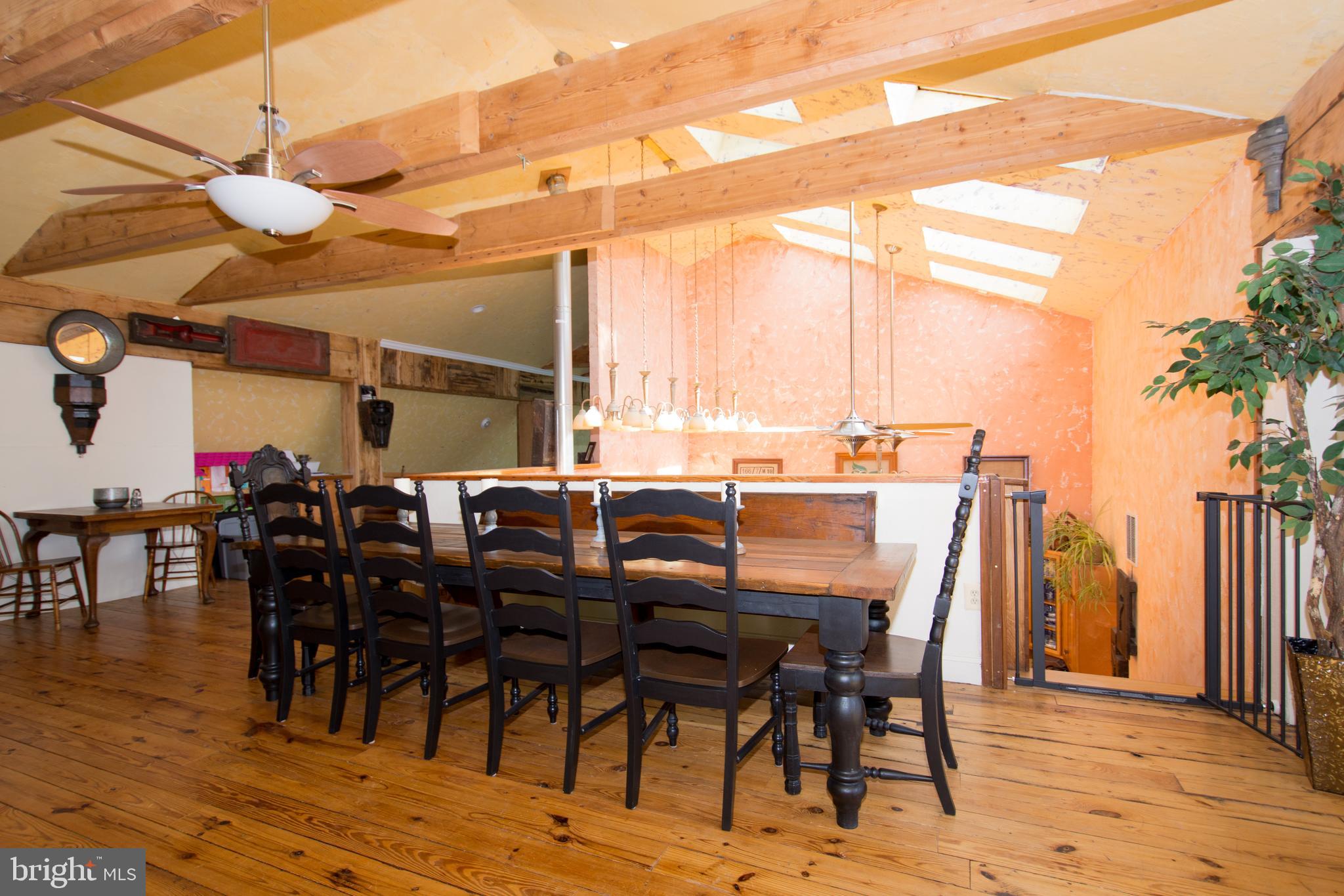 608 Charles Avenue Deale, MD 20751 - Photo 24 of 41 a view of a dining hall with lots of chairs and wooden floor