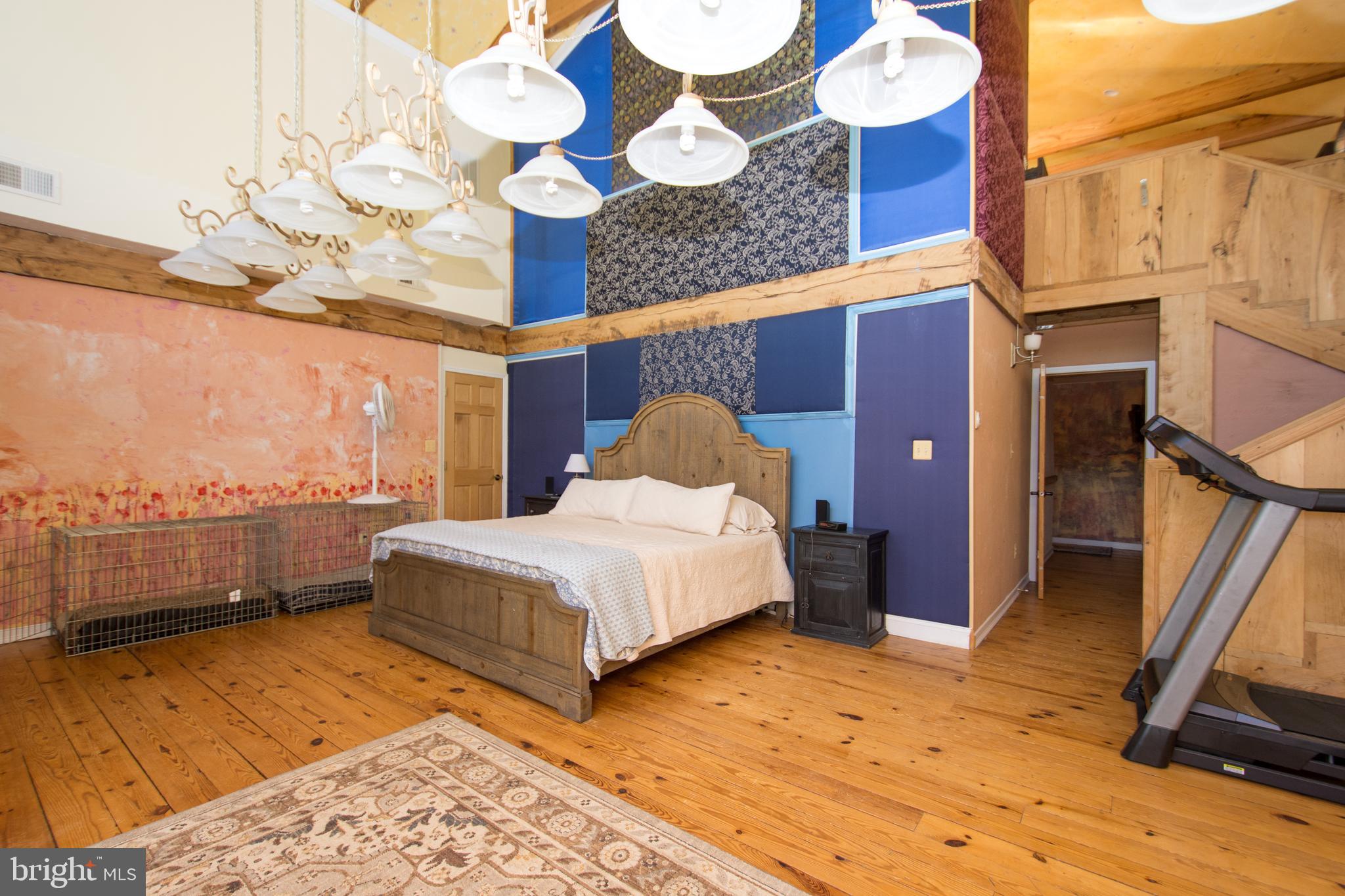 608 Charles Avenue Deale, MD 20751 - Photo 30 of 41 a spacious bedroom with a bed and wooden floor