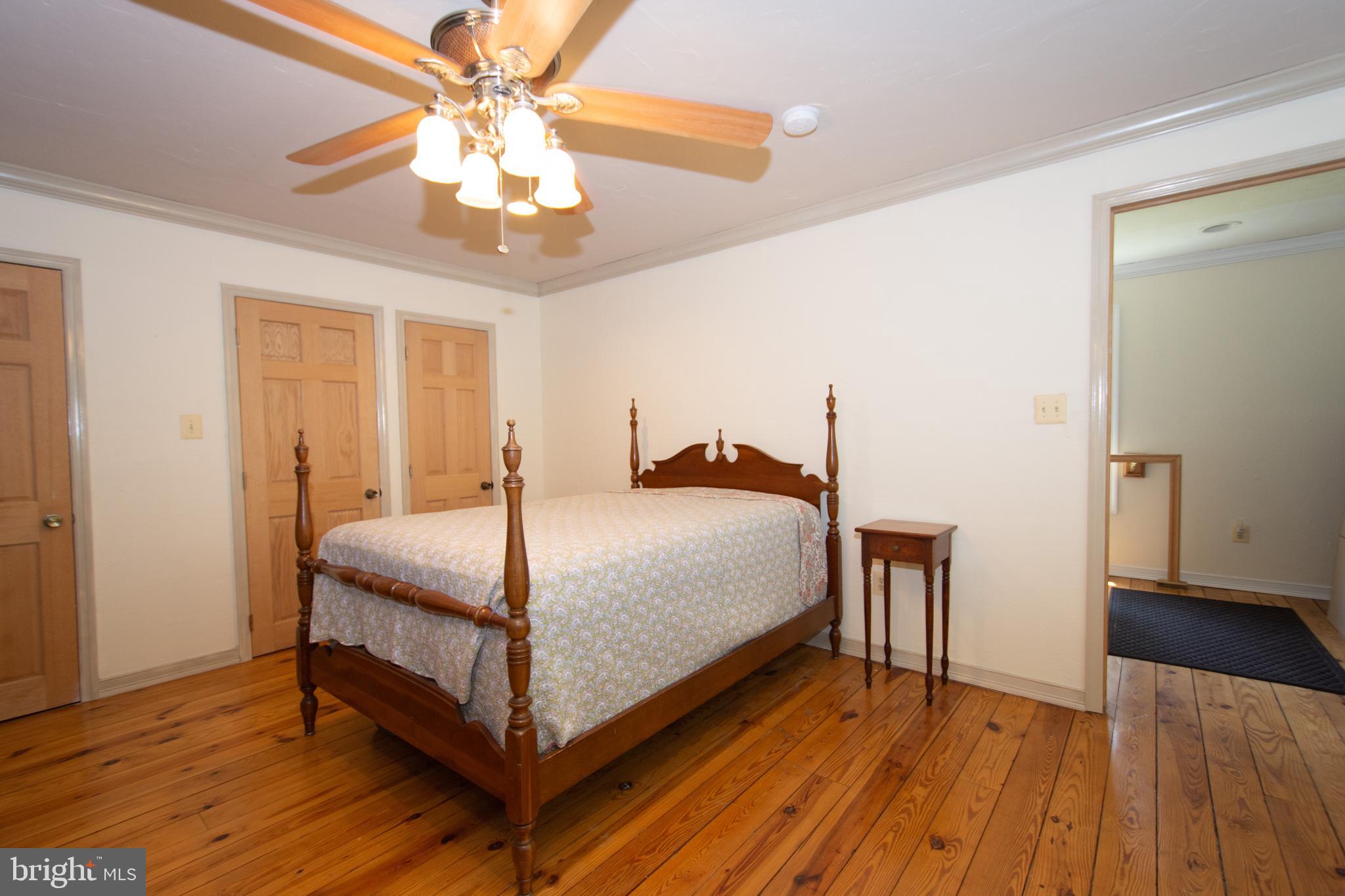 608 Charles Avenue Deale, MD 20751 - Photo 34 of 41 a bedroom with a bed and a chandelier