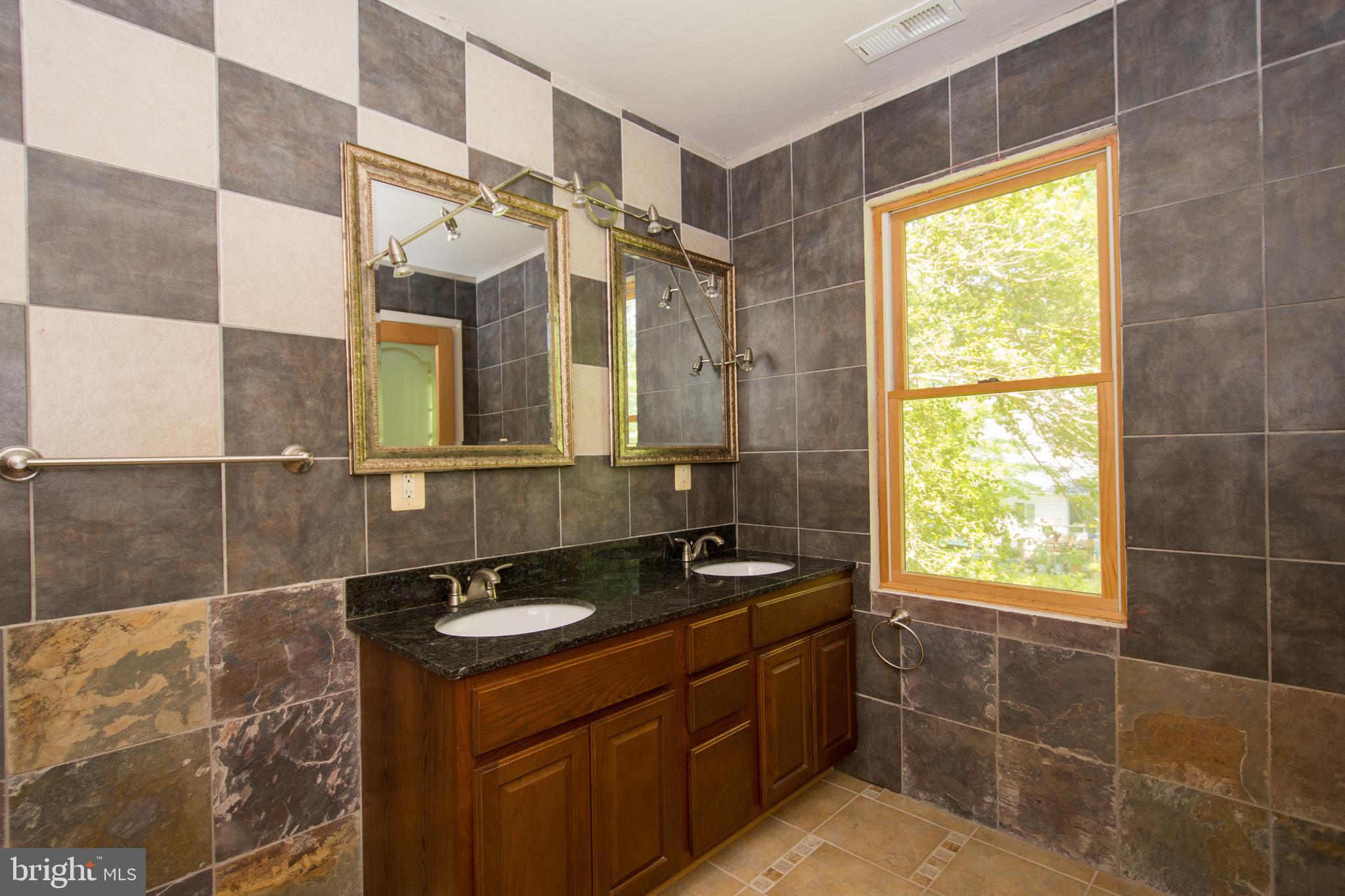 608 Charles Avenue Deale, MD 20751 - Photo 36 of 41 a bathroom with a sink and a mirror