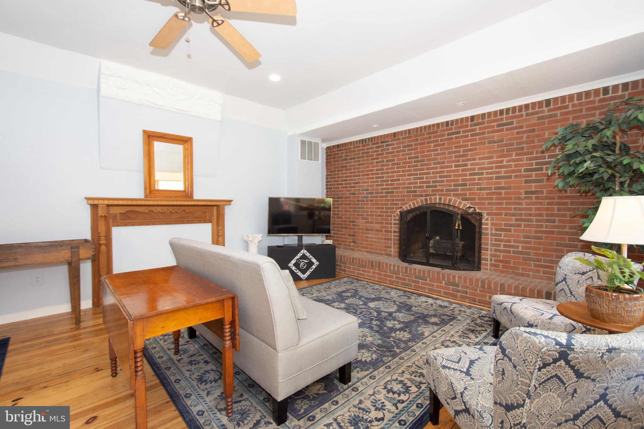608 Charles Avenue Deale, MD 20751 - Photo 4 of 41 a living room with furniture a flat screen tv and a fireplace