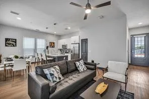 a living room with furniture and wooden floor