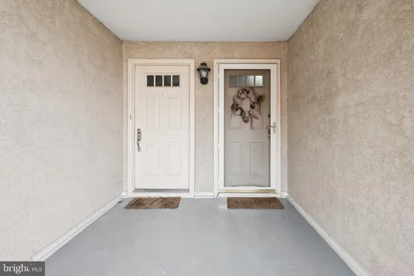 an empty room that has a grey walls