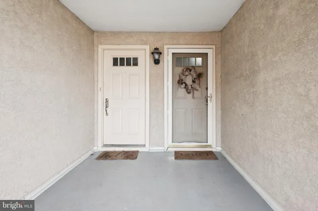 an empty room that has a grey walls