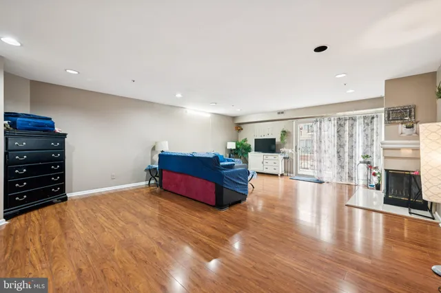 a spacious bedroom with a bed and a flat screen tv