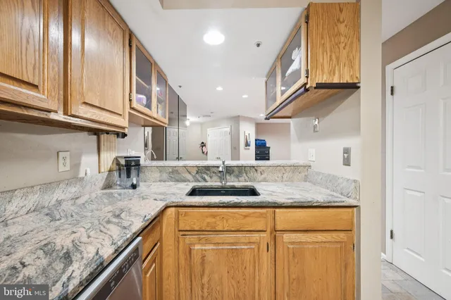 a kitchen with stainless steel appliances granite countertop a sink and cabinets