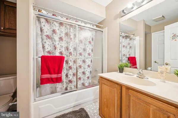 a bathroom with a sink vanity and a mirror