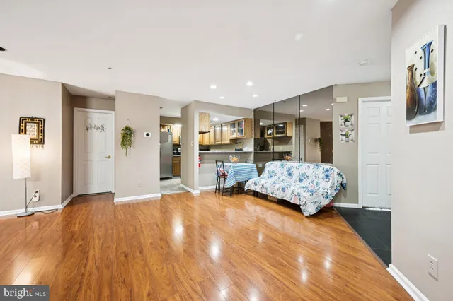 a living room with furniture and large mirror