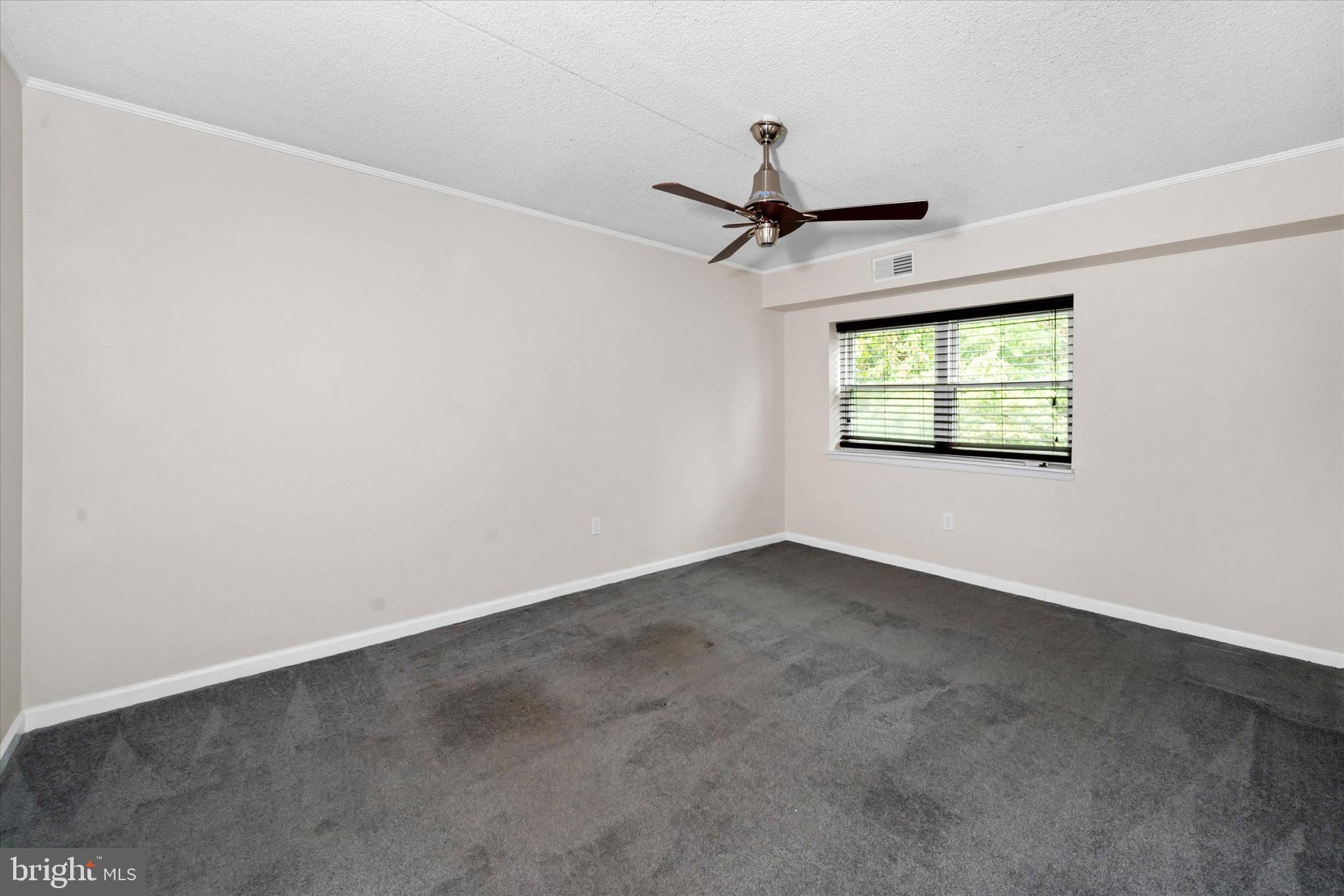 80 Welsh Tract Road, Unit G209 Newark, DE 19713 - Photo 16 of 26 an empty room with windows and ceiling fan