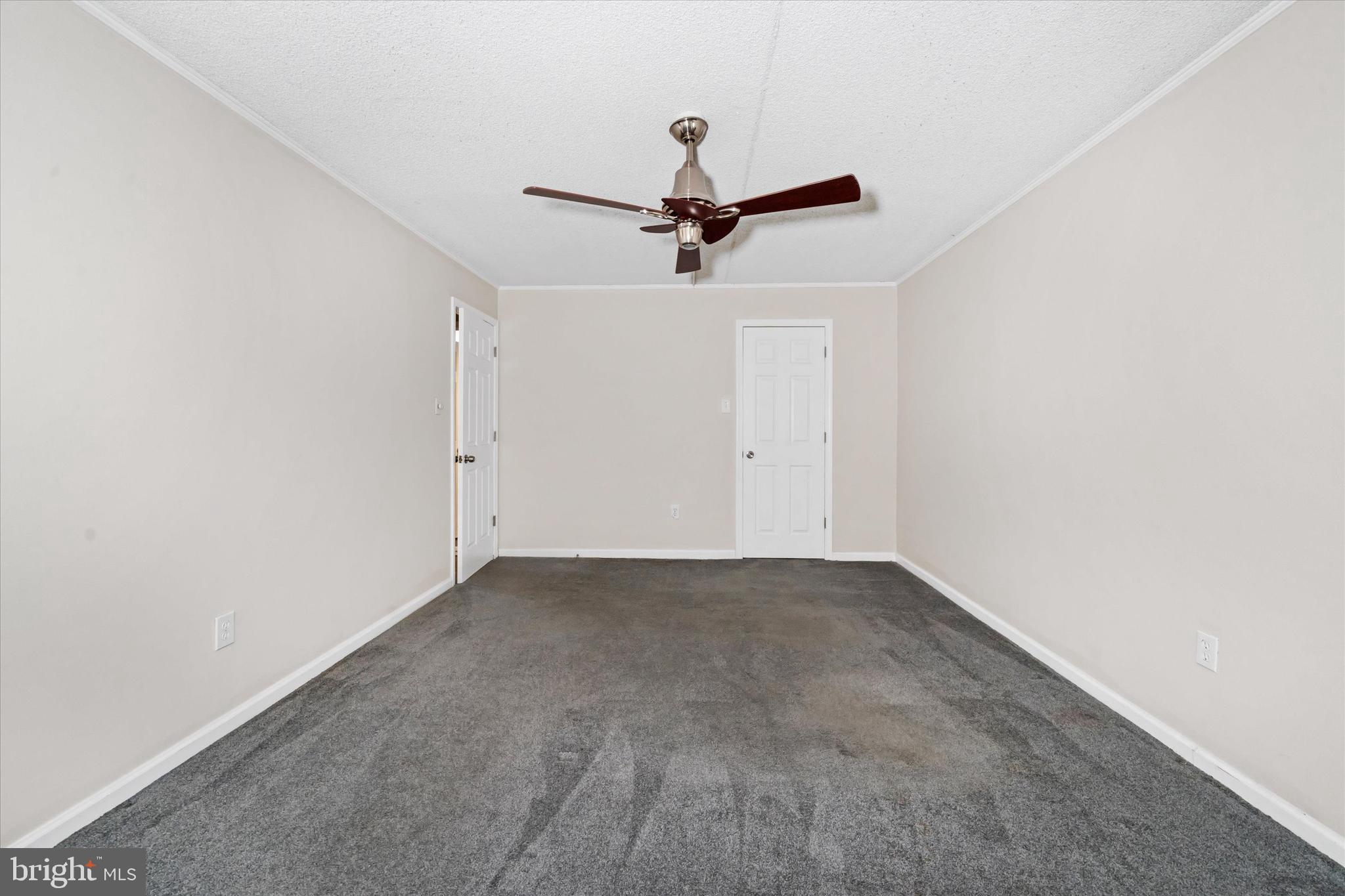 80 Welsh Tract Road, Unit G209 Newark, DE 19713 - Photo 18 of 26 an empty room with a ceiling fan and window